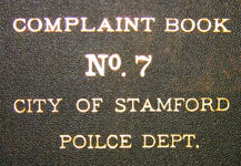 text on cover of police complaint book, note typo
