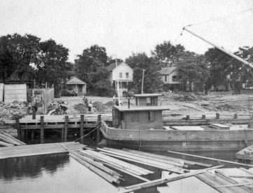 Getman & Judd lumber yard, 1898. Barge at the canal.