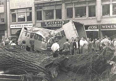Truck smashed by a falling tree, Main Street