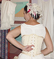 The back lacings of a corset would allow for a little space in between each side so the individual backbones would fit comfortably.